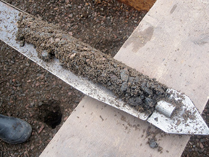 Soil on a thin metal object, photo.