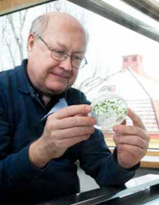 A man sitting by a bench in a laboratory, photo.