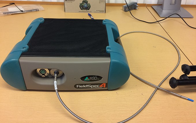 A flat, square machine that takes spectral images. Photo.