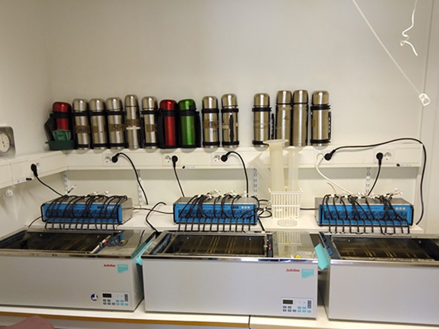 Three boxes with tubes in the back. Photo.