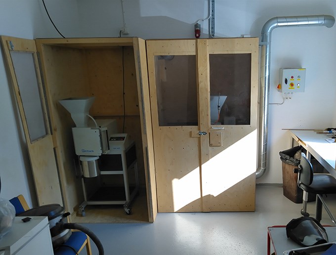 Two cabinets of which one is open and a mill is visible inside. Photo.