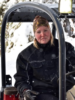 Woman in tractor in snow covered landscape