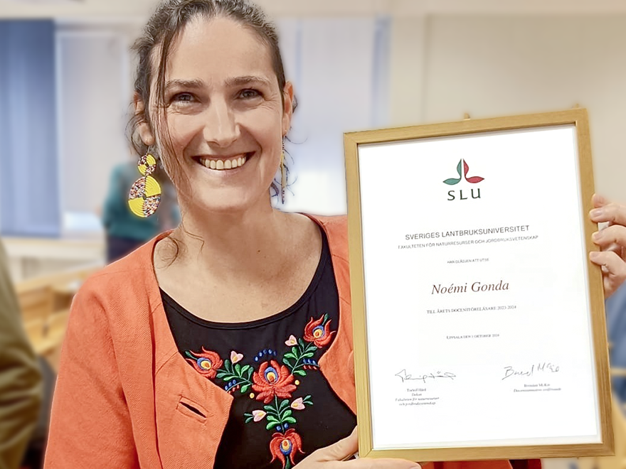Noemi showing her diploma.