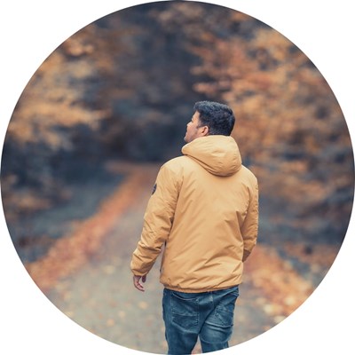 A man from behind in a forest. Photo.