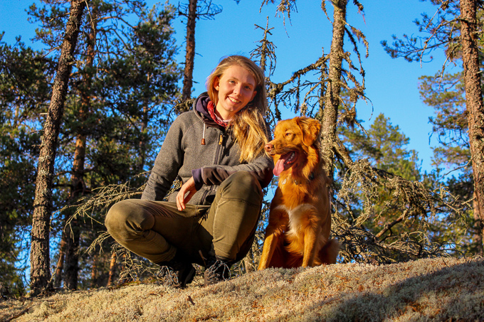 Carolin with her dog in a forest. Photo.