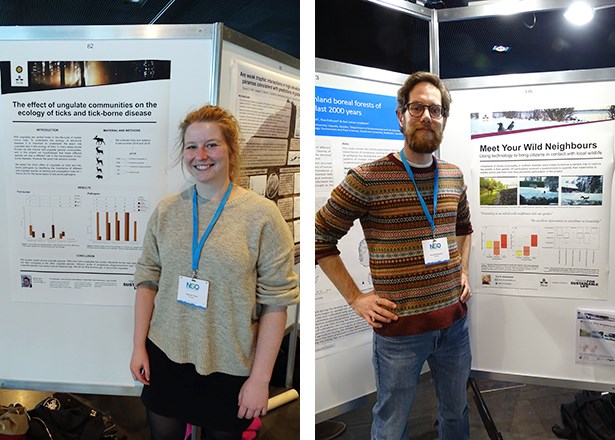  Tim and Nannet photographed next to large posters describing their research.