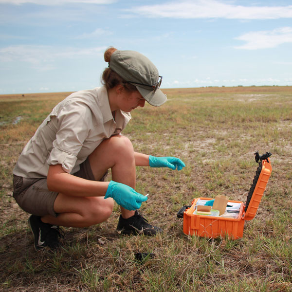 Amber with a box of tools doing field work.