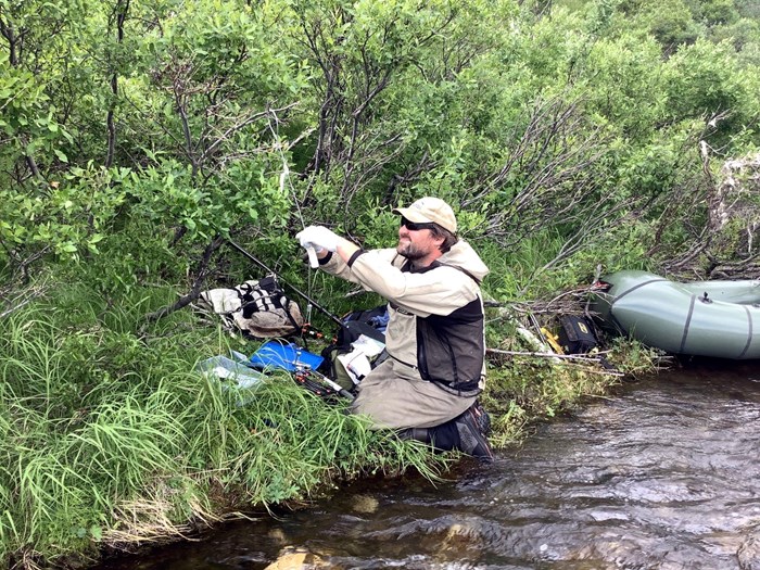 Field technician preparing experiment equipment. Photo. 