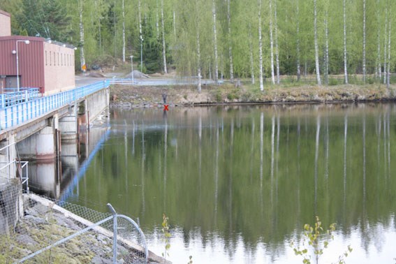 Inlet to water power plant and a cross pointing towards the sampling point. Edited photo.