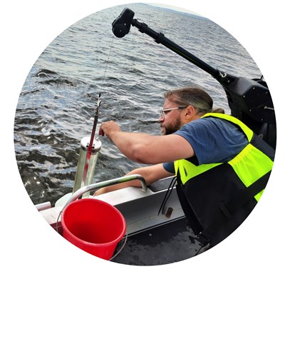 Sampling water from boat. Photo.