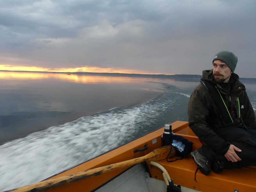 Man in boat on lake. Photo.