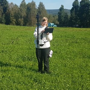 A person standing in a field with a Yara-N-sensor.