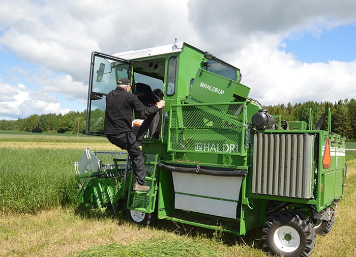 Man enters a combine harvester.