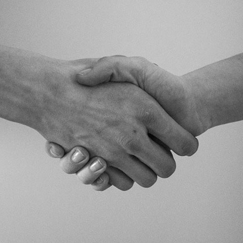 Handshake between two people, photo.