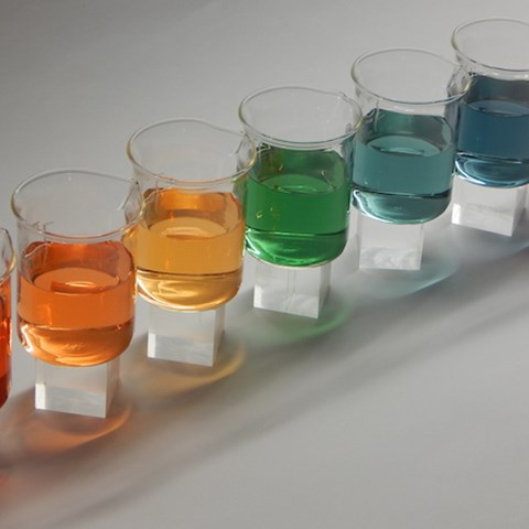 Beakers filled with liquids in different colours, photo.