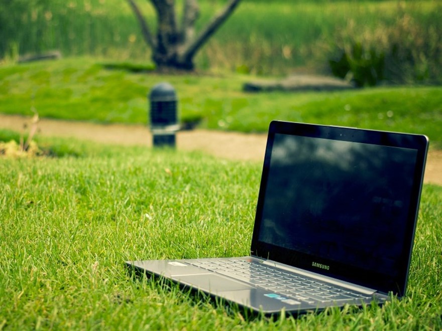 Laptop on a lawn, photo.