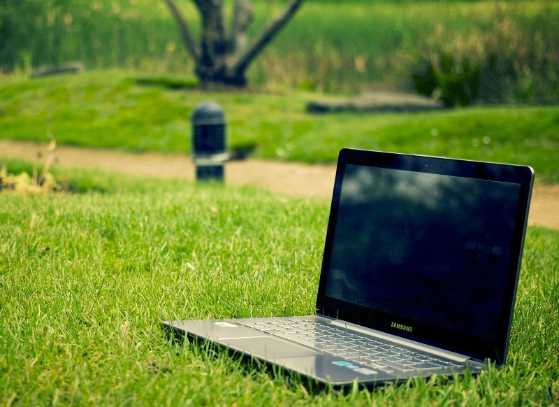 Laptop on a lawn, photo.
