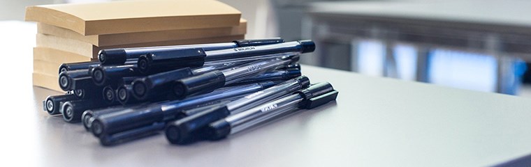 Books and pencils on a table. Photo. 