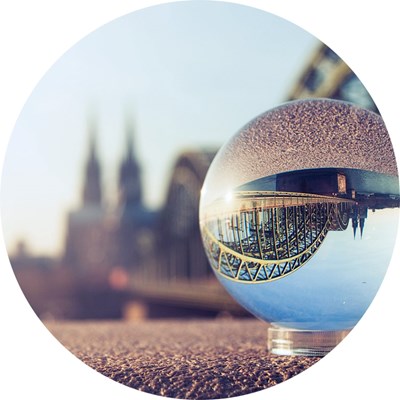 A bridge is mirrored in a glass ball, photo.