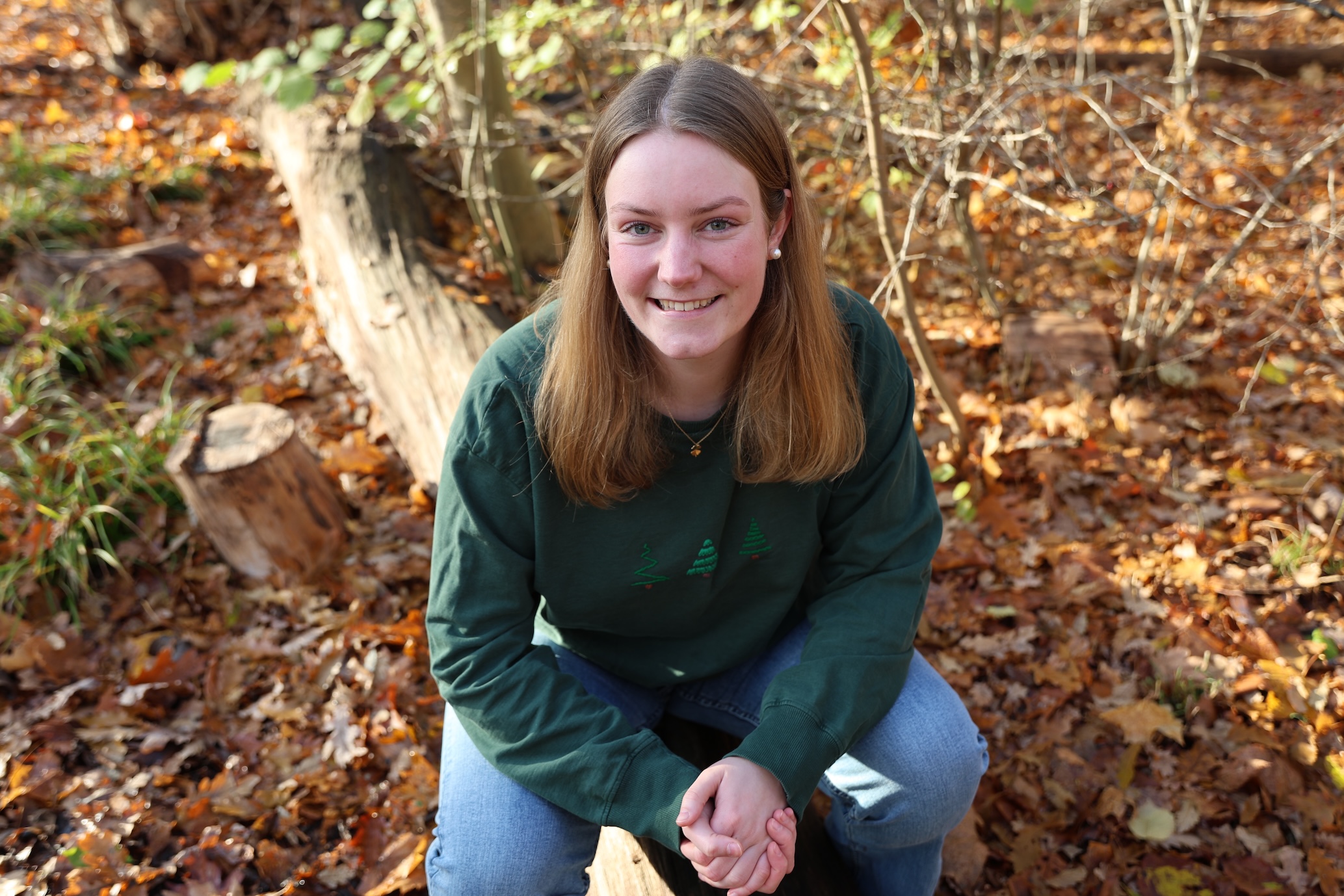 woman sitting on a tree branch