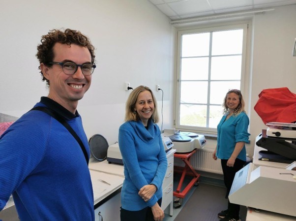 Three people standing in a lab