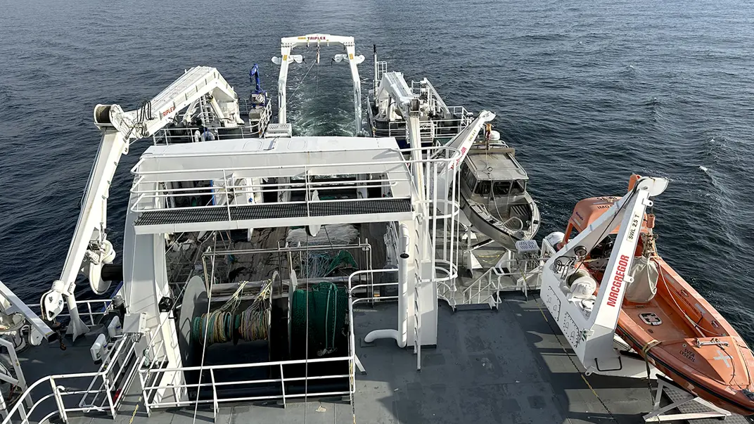 Smaller boat aside ship