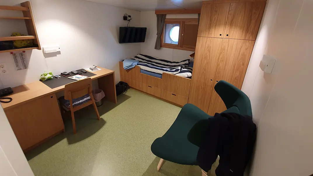 Inside of cabin with bed and desk
