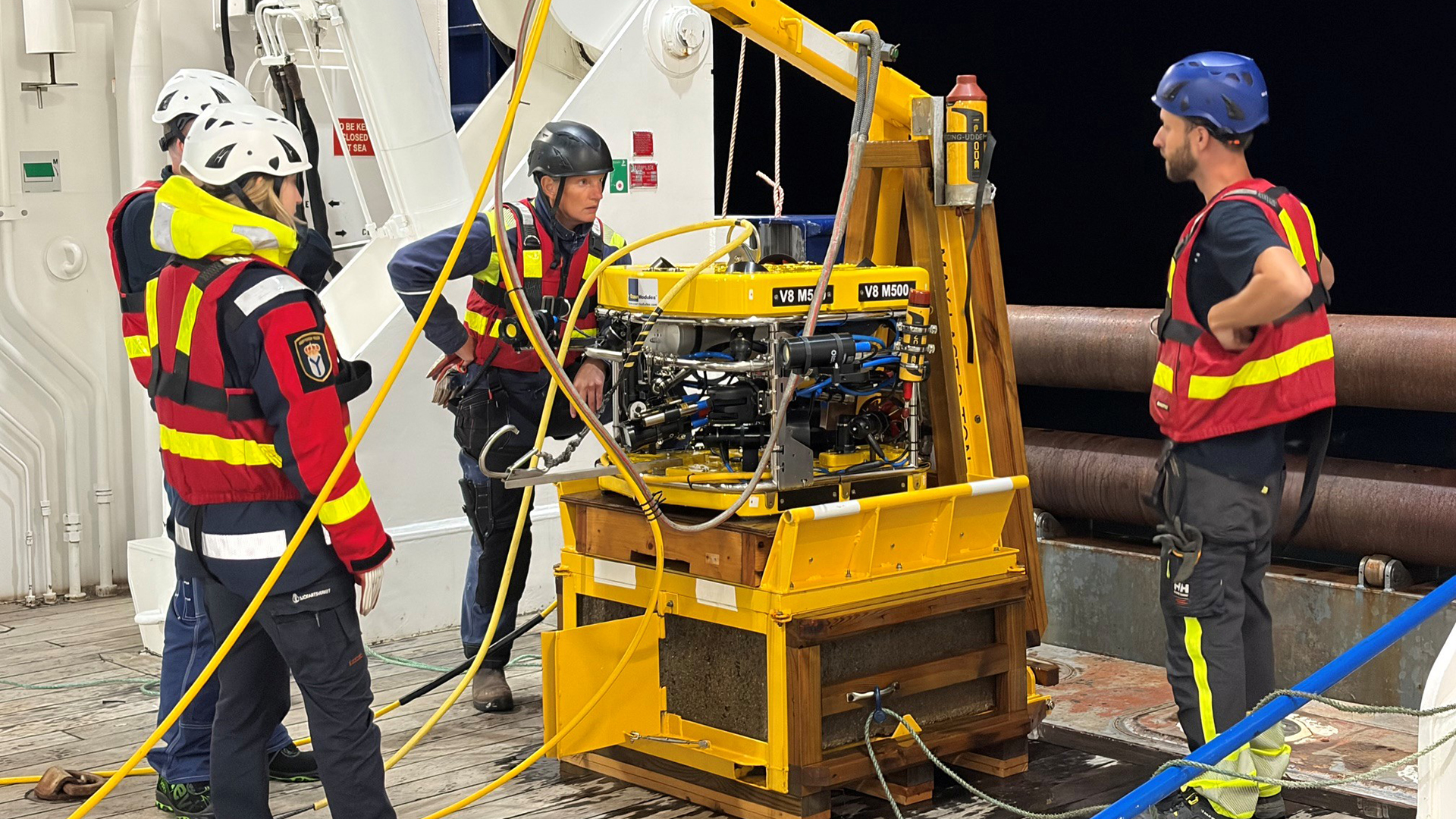 Persons on ship deck with ROV