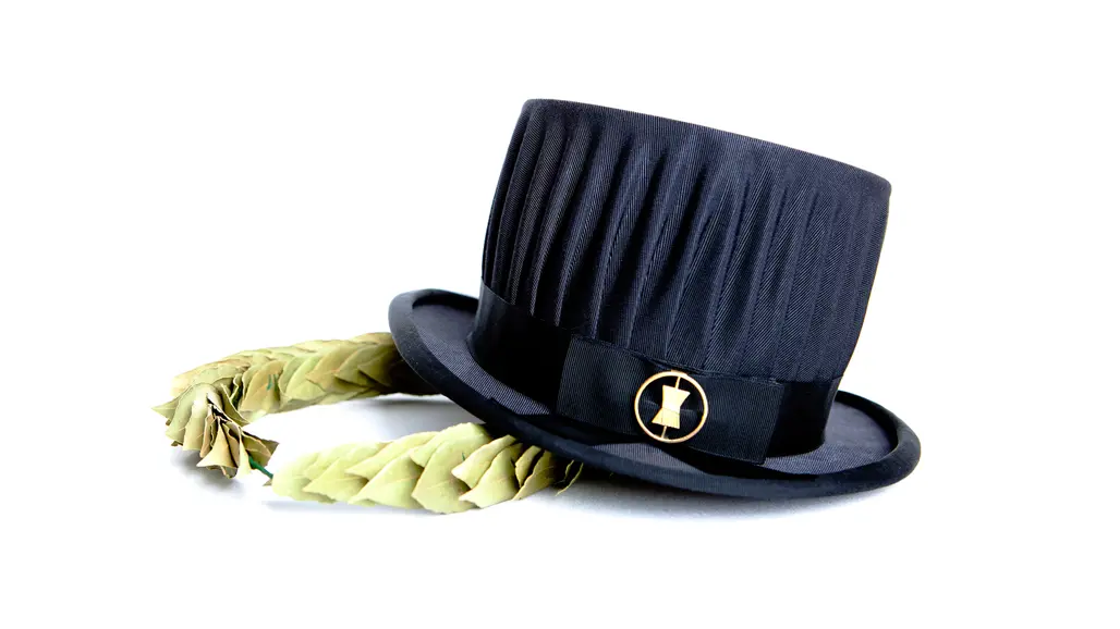 A black doctoral hat and a laurel wreath on white background