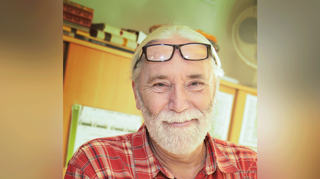 A man wearing glasses and a red shirt.