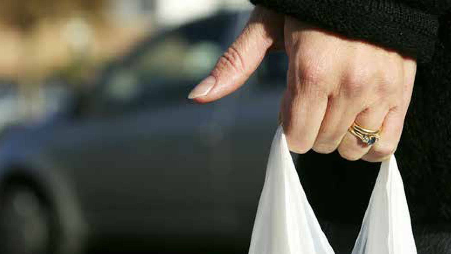 Hand holding a plastic bag.