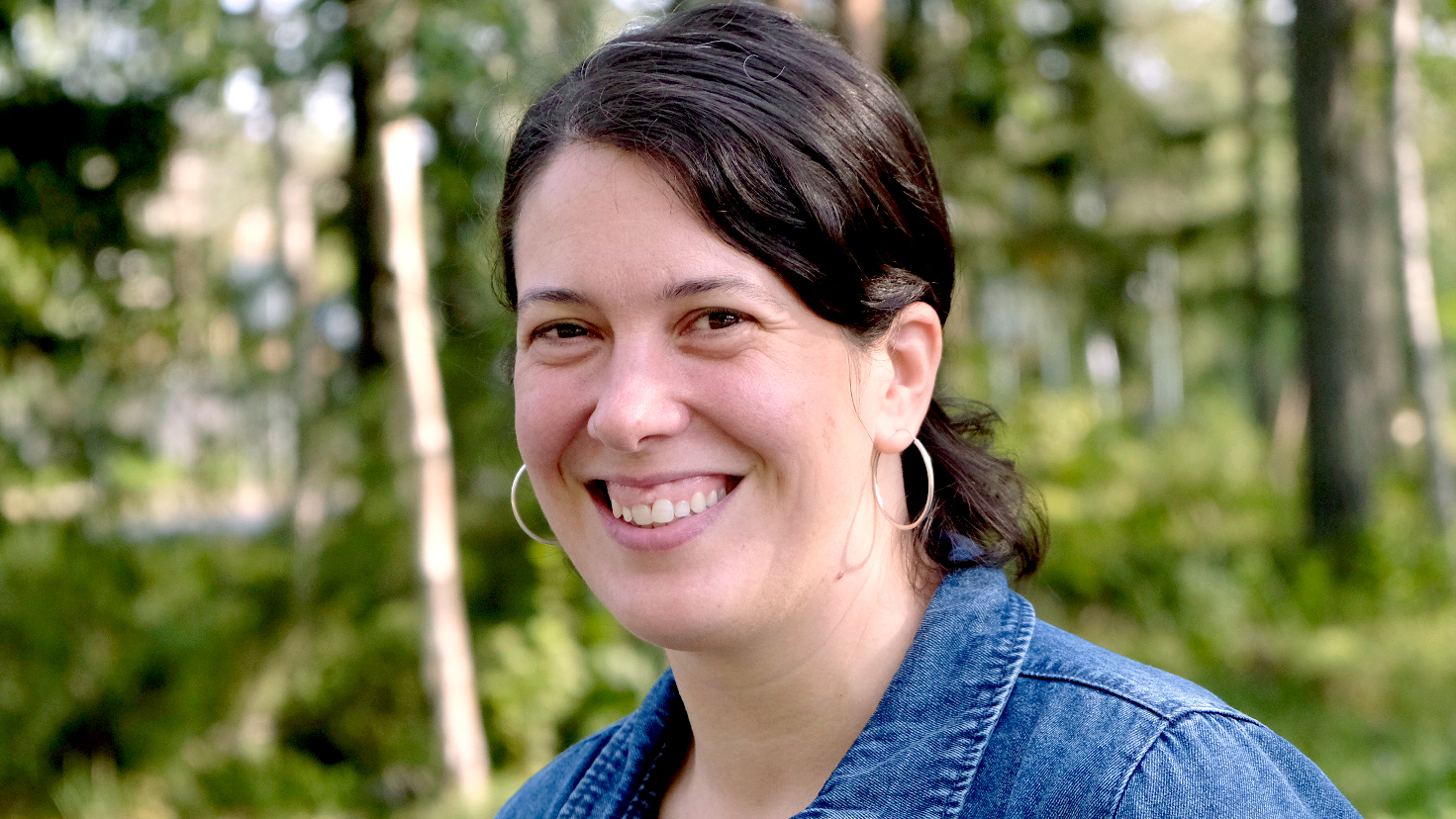 Main image of a woman with dark, styled hair.