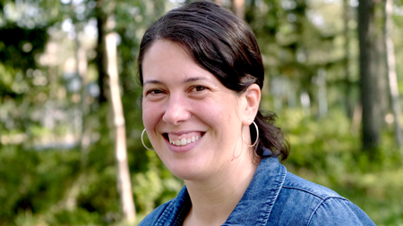 Main image of a woman with dark, styled hair.
