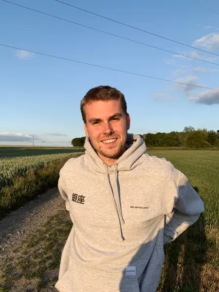 A man by a field. Photo.