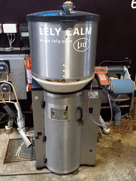 Milking machine in a barn setting.