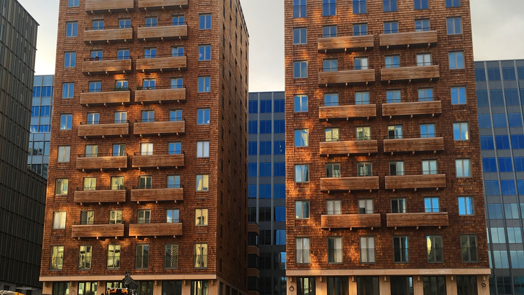 Photo of two multi-family houses being built next to each other.