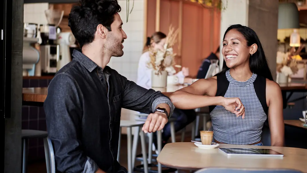 Two people are greeting