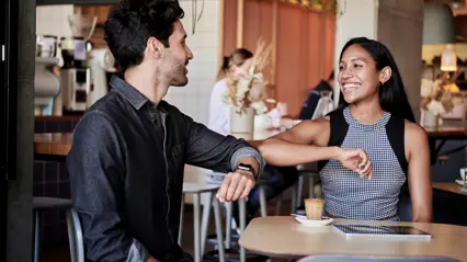 Two people are greeting