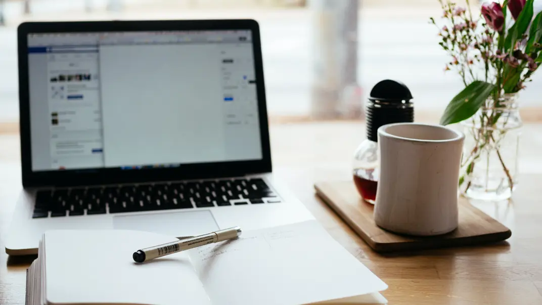 Laptop and notebook on table