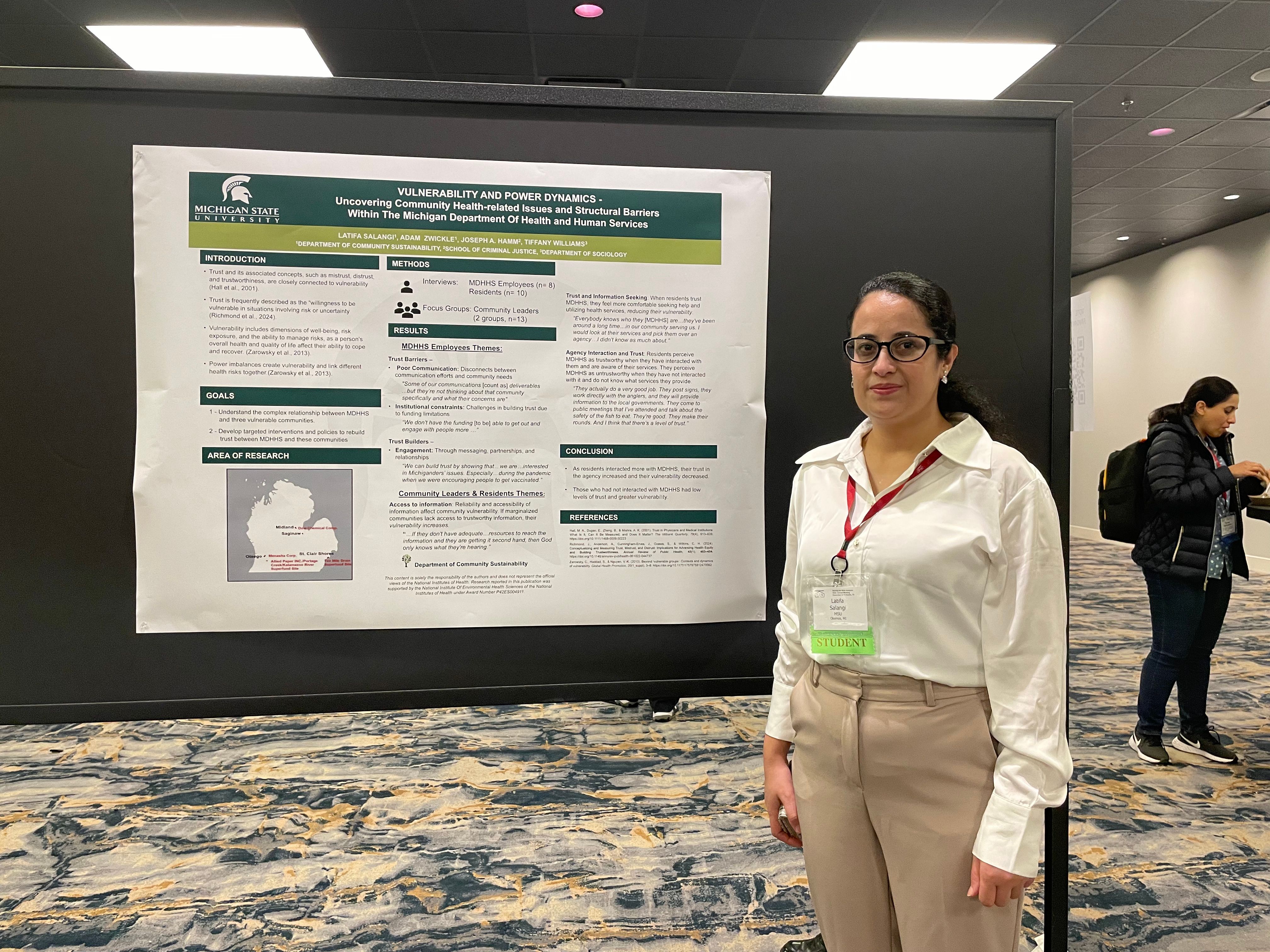 Woman standing in front of poster