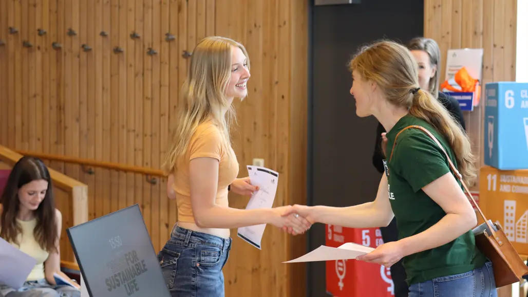 Student receives diploma from coordinator