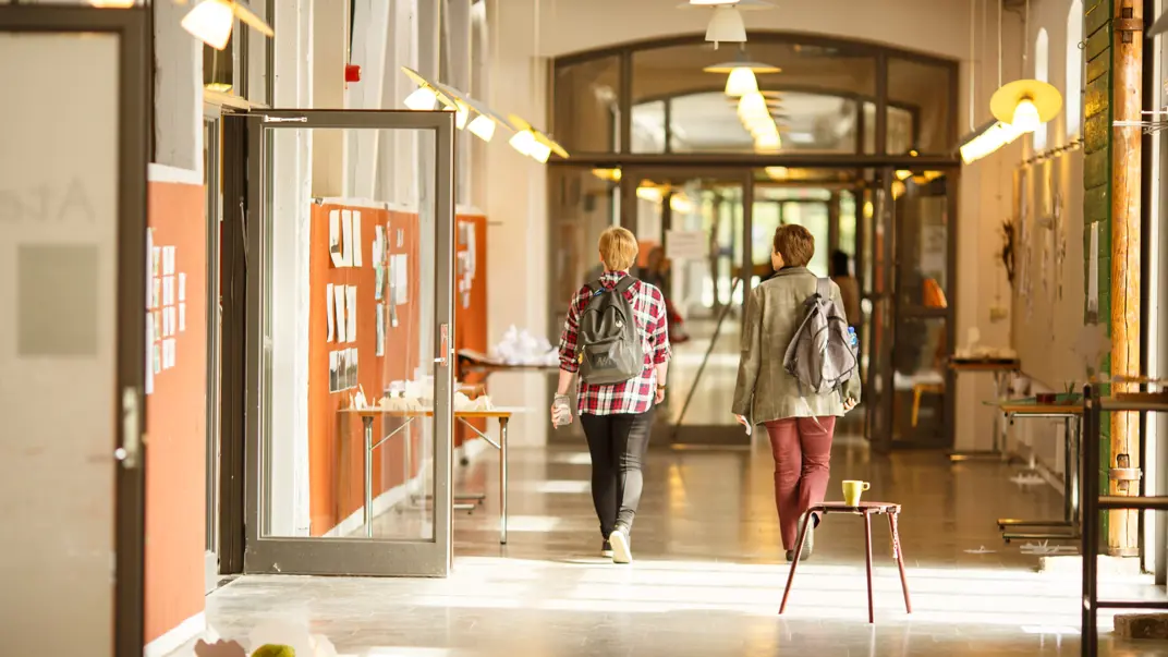 Two students in a corridor