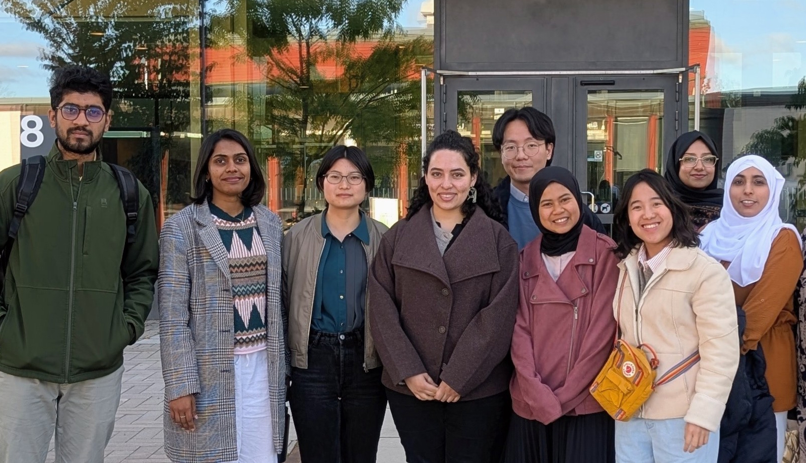 A group of students standing in front of SLU's entrance