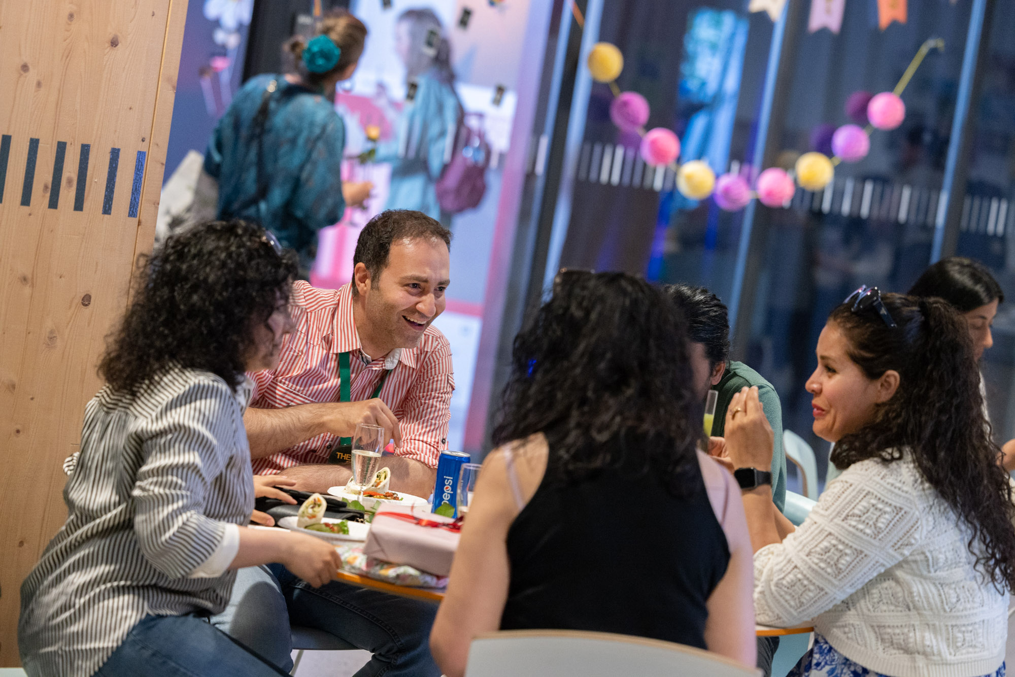 Students sitting around a table during a networking reception.